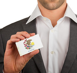 Image showing Businessman is holding a business card, Illinois