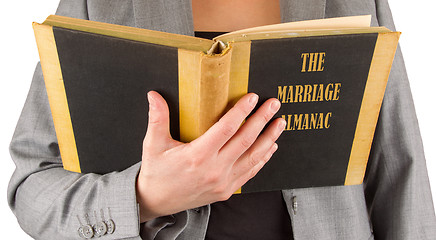 Image showing Woman reading a marriage almanac