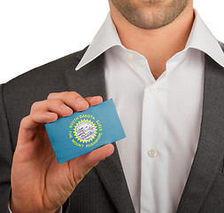 Image showing Businessman is holding a business card, South Dakota