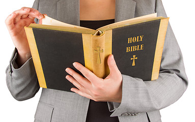 Image showing Woman in business suit is reading a holy bible