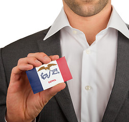 Image showing Businessman is holding a business card, Iowa