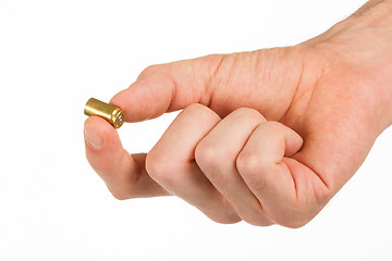 Image showing Hand holding an empty bullet shell