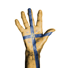 Image showing Hand of an old woman, wrapped with a pattern of the banner of th