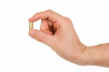 Image showing Hand holding an empty bullet shell