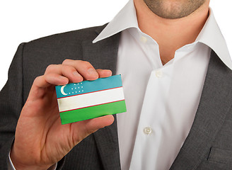 Image showing Businessman is holding a business card, Uzbekistan