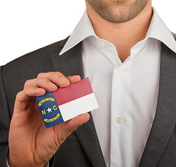 Image showing Businessman is holding a business card, North Carolina