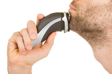 Image showing Young man shaving his beard off