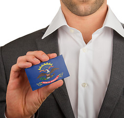 Image showing Businessman is holding a business card, North Dakota