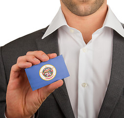 Image showing Businessman is holding a business card, Minnesota