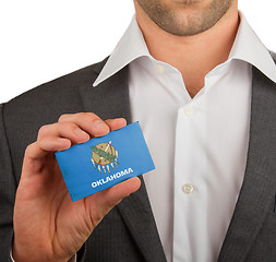 Image showing Businessman is holding a business card, Oklahoma