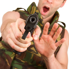 Image showing Soldier in camouflage vest is holding a gun