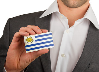 Image showing Businessman is holding a business card, Uruguay