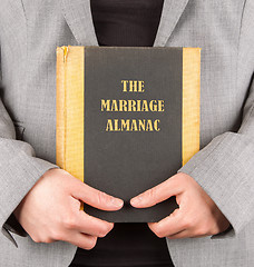 Image showing Woman holding a marriage almanac