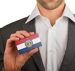 Image showing Businessman is holding a business card, Missouri