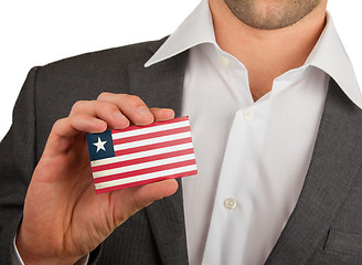 Image showing Businessman is holding a business card, Liberia
