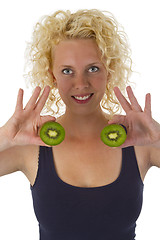 Image showing Young woman holding Kiw Fruit