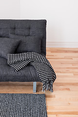 Image showing Gray sofa with cushions and throw 