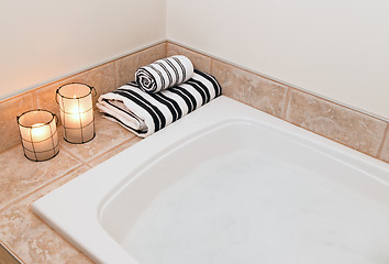 Image showing Towels, cozy lanterns and bath with foam