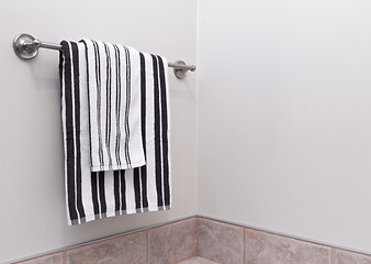 Image showing Stripped bathroom towels on towel holder