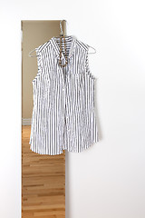 Image showing White striped blouse hanging on a mirror