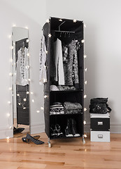 Image showing Clothes organizer and mirror decorated with lights