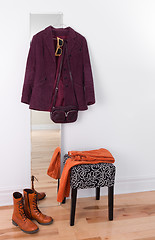 Image showing Purple jacket hanging on a mirror