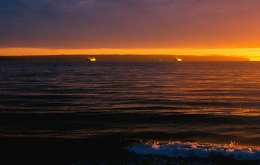 Image showing Sunset and freighters