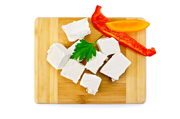 Image showing Feta cheese pieces on the board with pepper