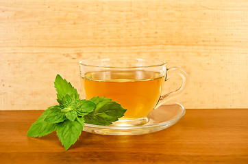 Image showing Herbal tea with mint on a wooden board