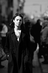 Image showing Young woman among human rush in the city