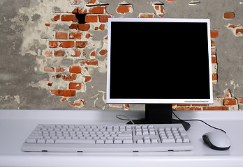 Image showing PC with black desktop and old grunge brick wall background