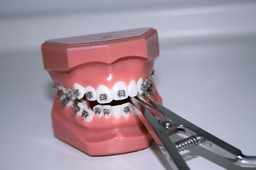 Image showing Teeth with braces and dental instrument 