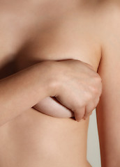 Image showing Woman holding her breast