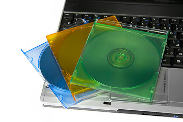 Image showing Colored cd`s on a laptop