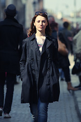 Image showing Young woman among human rush in the city