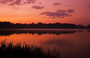 Image showing Romantic sunset on the lake with fog