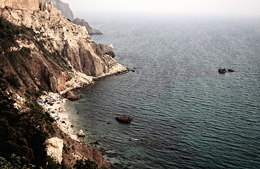 Image showing Sea with rocky beach at sunset