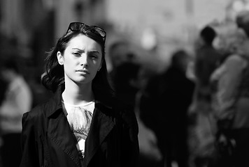 Image showing Young woman among human rush in the city