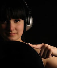 Image showing Naked girl with vinyl plate and headphones