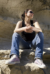 Image showing Model sitting on the rocks. Urban style