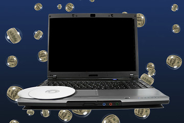 Image showing White cd`s on a laptop with black desktop. Cool dollar bubbles b