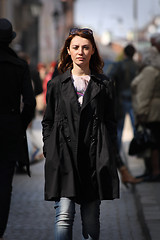 Image showing Young woman among human rush in the city