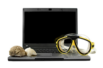 Image showing Sea shells and Yellow diving mask on a laptop isolated. Sea trav