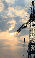 Image showing Construction crane silhouette with cool sunset background