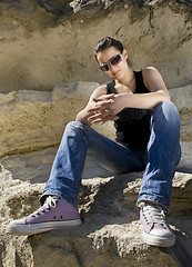 Image showing Model sitting on the rocks. Urban style