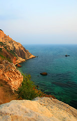 Image showing Sea with rocky beach at sunset