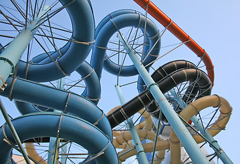 Image showing Twisting, colorful water chutes wind around