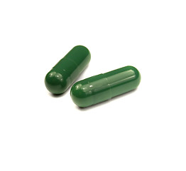 Image showing Two green pills isolated