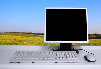Image showing PC with black desktop and green field background