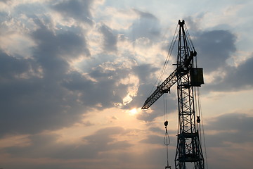 Image showing Construction crane silhouette with cool sunset background